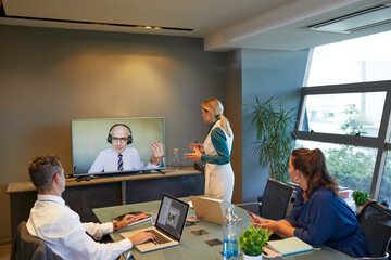 Businessmen talking by video conference