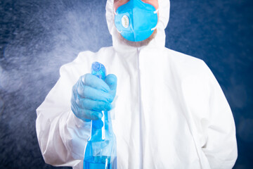 Covid-19 disinfection. Man in white hazmat suits cleaning and disinfecting coronavirus.