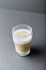 Coffee with milk on gray background. Close up. Copy space.