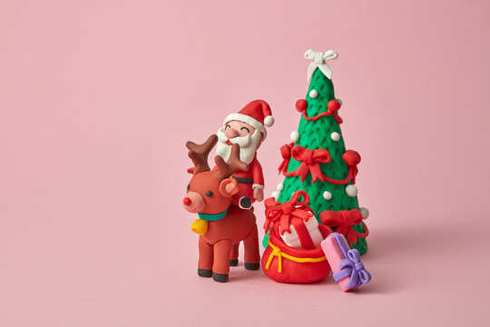 Craft plasticine Santa Claus ride a deer with gifts.