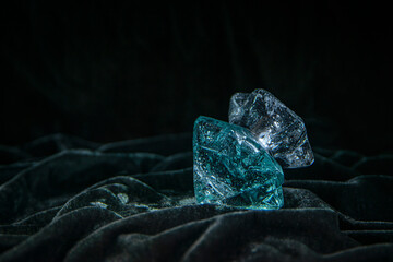 perfume bottle on dark velvet, diamond shaped perfume bottle, crystal shaped bottle with water drops, sexy eau de toilette cold crystal shaped, copy space