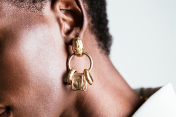 Crop black woman in golden earrings