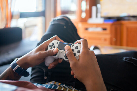 Young Man Playing Video Games At Home.