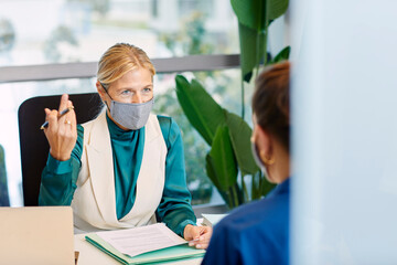 Executive talking to co-worker