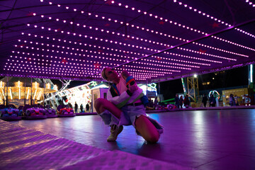 Trendy woman having fun and dancin in a fairground