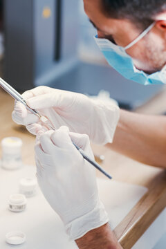 Dental Technician Making New Dental Prosthetics in Laboratory.