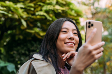 Close up of an Asian Woman Using a Mobile Phone