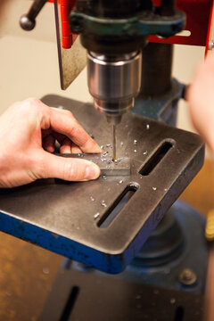 A small piece of metal being drilled