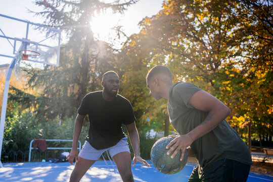 Two Friends Playing Basketball.