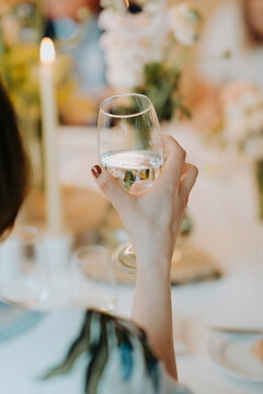 Female hand holding a glass of wine