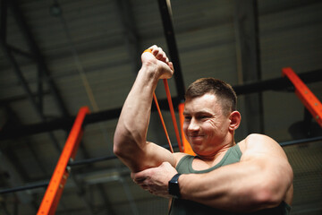 Man building up muscles of upper body