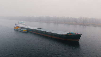 Top-view of two cargo ships like a child and it's parent