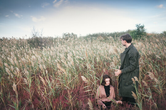 Young couple at sunset fall reeds.