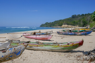 Landscape view of Wanokaka beach with colorful outrigger fishing boats, Lamboya, Sumba island, East Nusa Tenggara, Indonesia