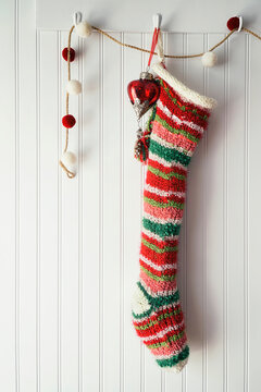 Knitted christmas stocking hanging on hook