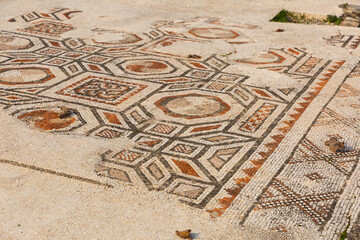 Closeup of patterns of ancient stone mosaic for facing floor and walls in ruined Roman bath...