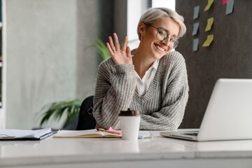 Happy young woman making distance video call