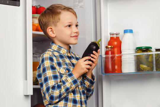 Little Boy Standing Near The Open Fridge