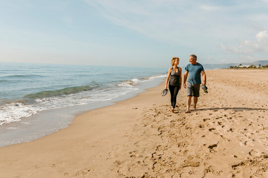 Mature couple exercise on the beach