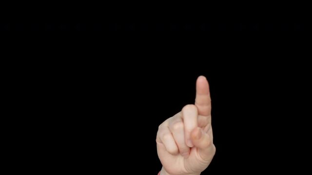 Close-up view of female finger touching something on black background. Cropped shot of hand pointing with finger at copy space on black background