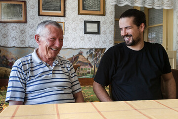 Grandfather and his Adult Grandson at Home