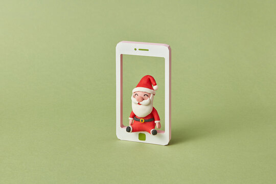 Handmade plasticine Santa Claus in a smatrphone frame.