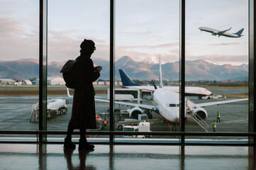 A passenger with a backpack waiting to board the plane