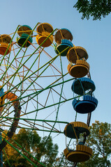 a colourful ferris wheel. front view. against the blue sky on a sunny day