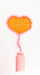 Vitamins of different types, yellow and peach color, in the form of a heart flying out of a plastic bottle. Isolated white background.