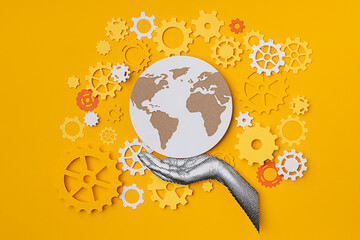 Hand holding the world with gears