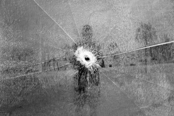 Self-portrayed with a glass broken by a bullet.