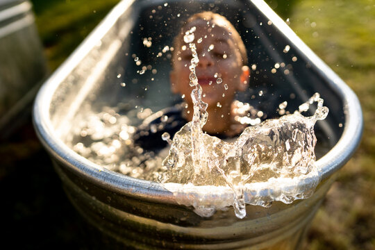 Splashing child in metal pool