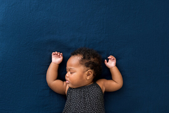 Simple baby laying on bed