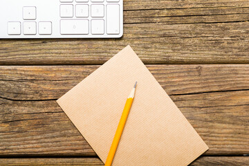 place of work, recycled paper, pencil, keypad, old wooden table background