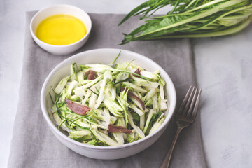 Puntarelle alla romana or asparagus Catalonian chicory salad with anchovy dressing and olive oil,...