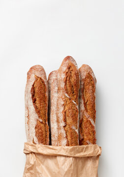 Paper bag with fresh natural french baguettes.