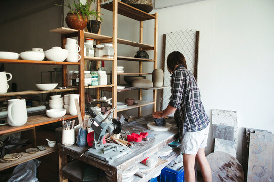 Female artisan makes ceramic products.