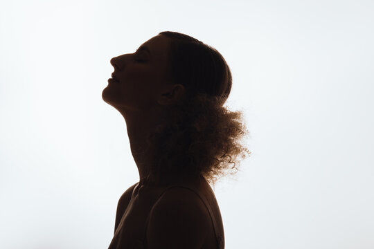 Silhouette of anonymous woman with curly hair
