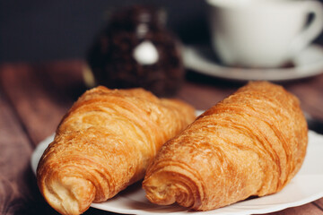 fresh croissants on a plate on the table breakfast dessert