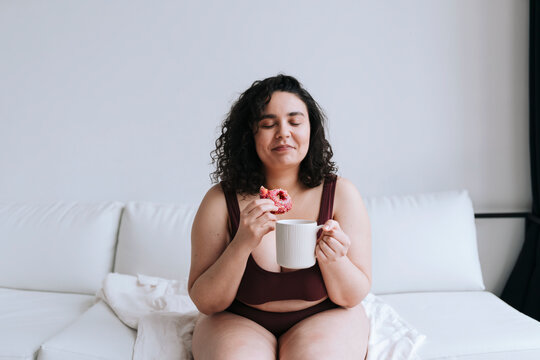 Young plus size woman with donut.