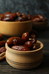 Bowl with dried dates on wooden table