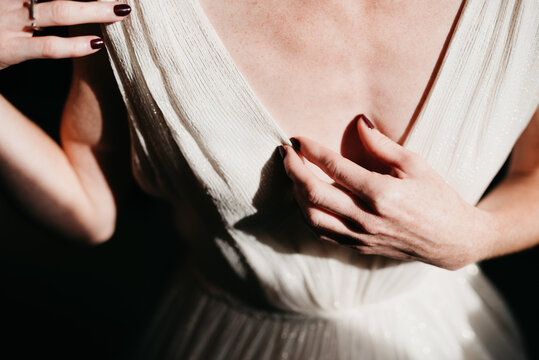 closeup of bride getting ready while sun hits her fragile skin