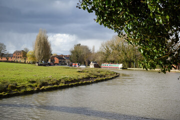 Fototapeta na wymiar Canal waterway leading to a rural village in england