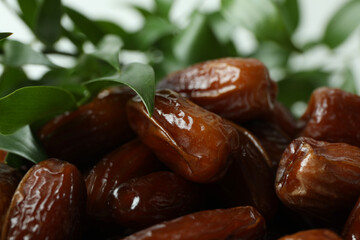 Tasty dried dates and leaves, close up