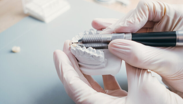 Dental Technician Making New Dental Prosthetics in Laboratory.