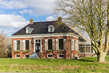 Fototapeta premium Front facade of a historic farm in the recreation area Kardinge near Groningen, Netherlands