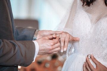 newlyweds put on a wedding ring at the ceremony