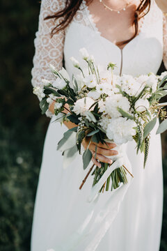 Bohemian Indie Bride in cute romantic wedding dress with wedding bouquet
