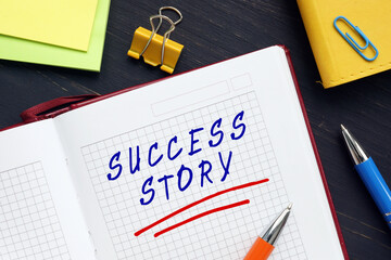Business concept meaning SUCCESS STORY with inscription on the piece of paper. An account of the achievement of success, fortune, or fame by someone or some enterprise.