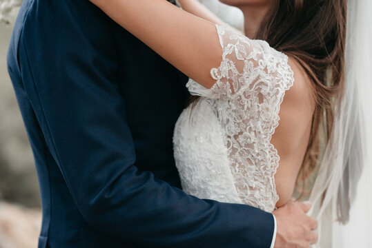 bride and goom holding each other close